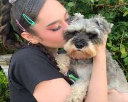 The star is accompanied by a cute dog in her home.